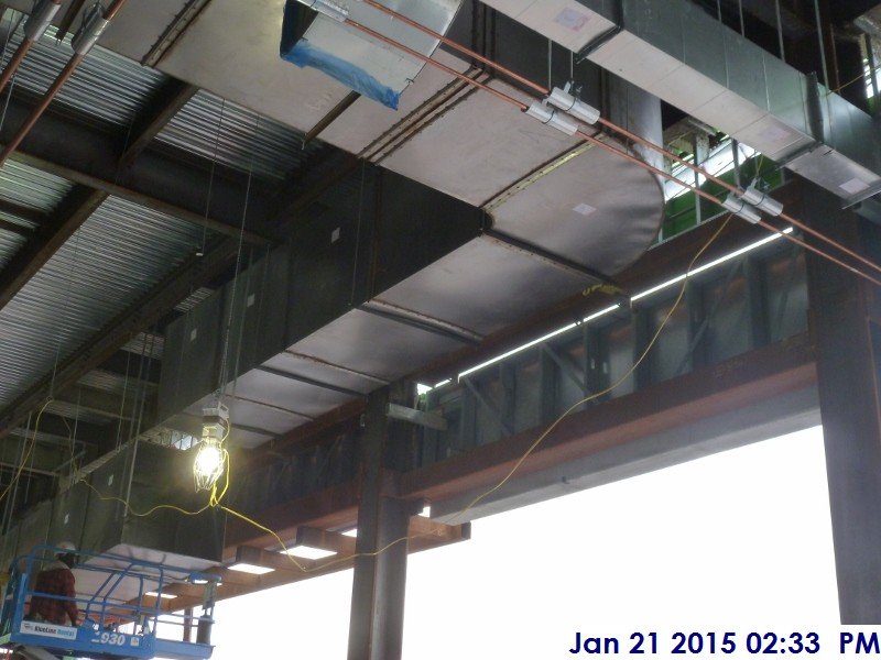 Installing black iron duct work at the 4th floor Facing South